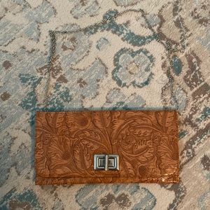 “Tooled” clutch with removable chain strap